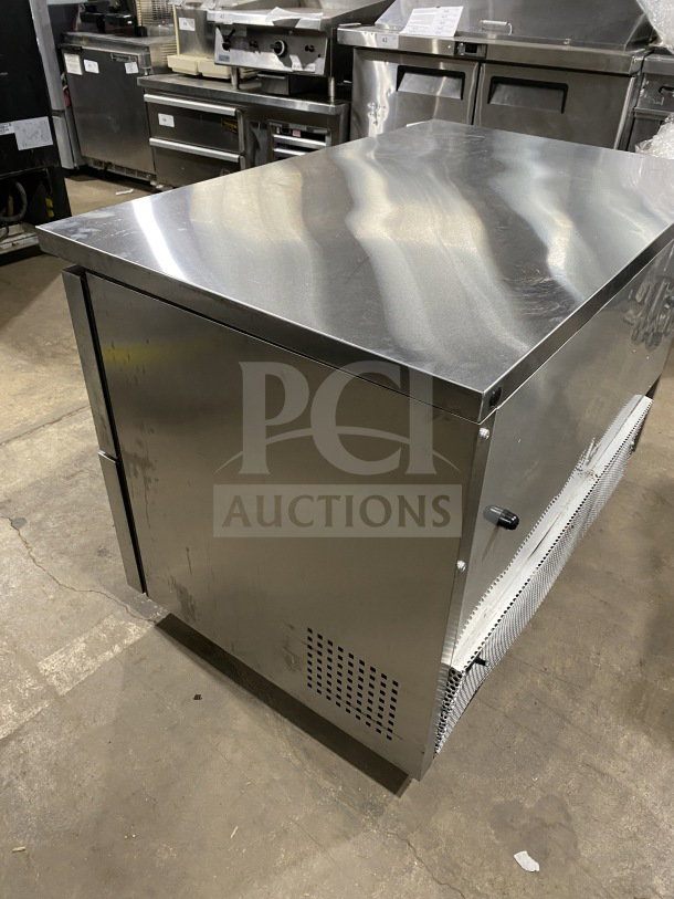 True TUC-48F-D-4-HC stainless steel 4-drawer undercounter freezer with marble-style worktop, 48" wide, on casters.