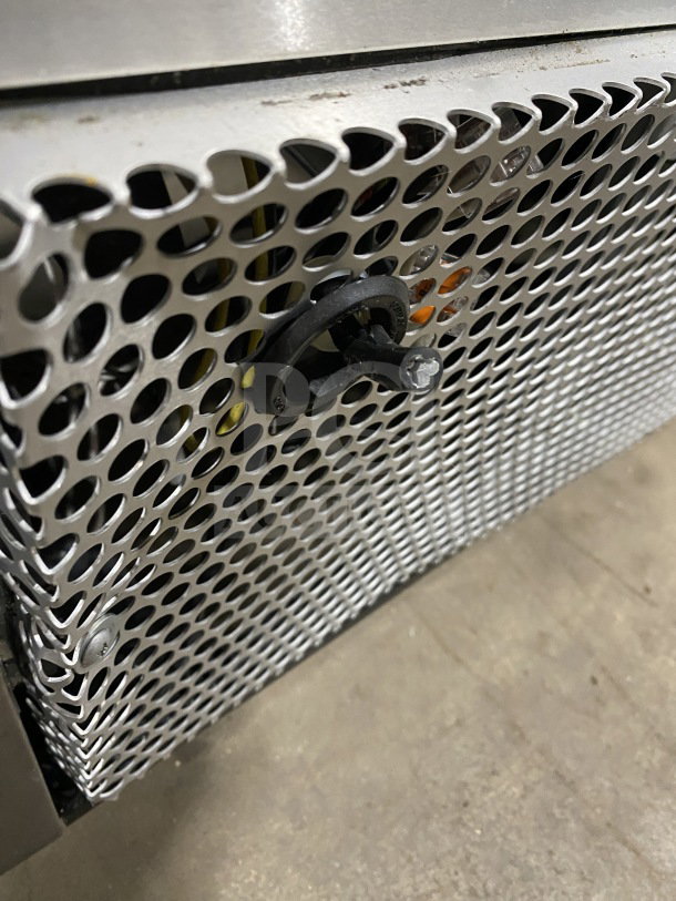 True TUC-48F-D-4-HC Undercounter Freezer with stainless steel mesh vent detail, working condition, 115V, on casters.