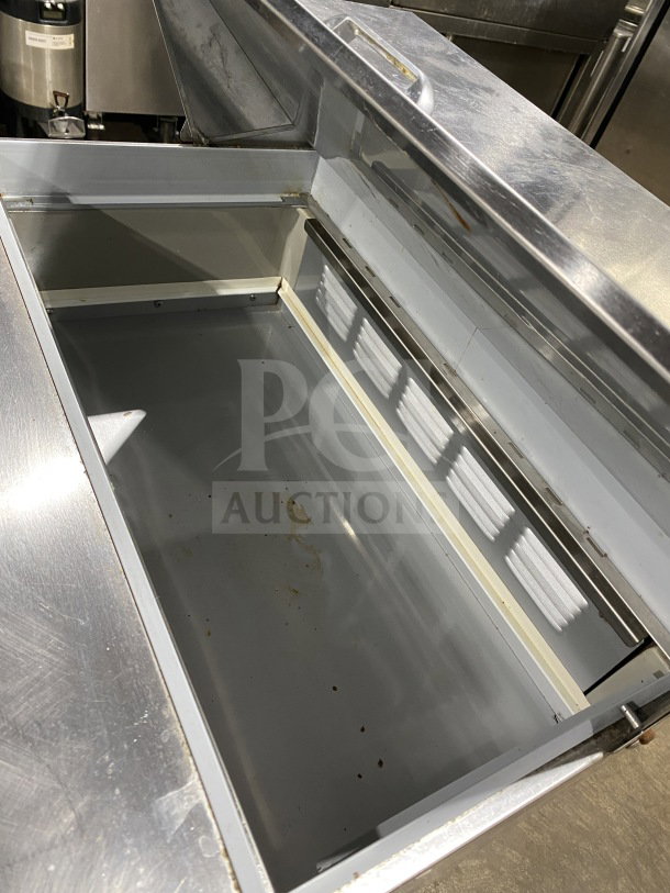 Beverage Air stainless steel refrigerated sandwich prep table, model SPE27HCB, with single door storage and poly rack.