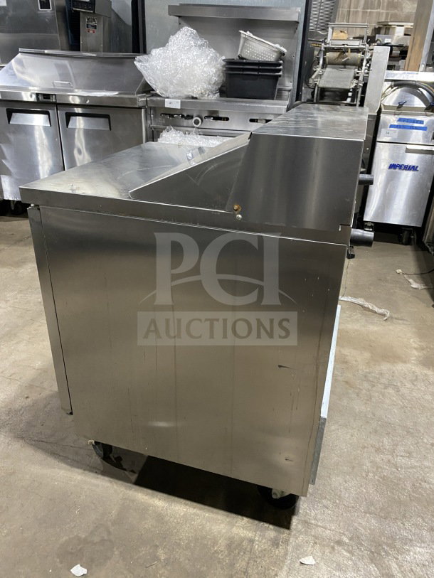 Beverage Air SPE27HCB stainless steel refrigerated sandwich prep table on casters, with single door storage and poly-coated rack.