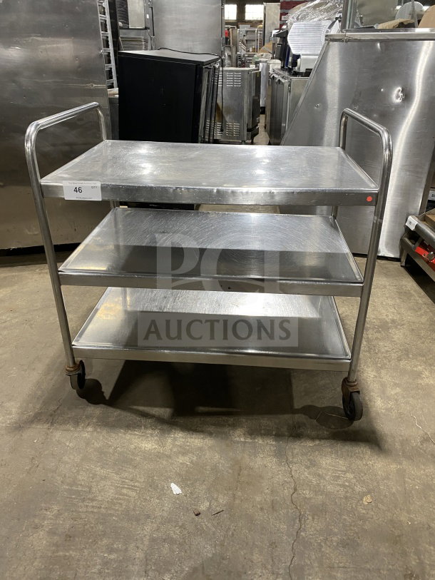 Commercial stainless steel utility trolley with 3 compartments on casters, good condition, item tag reads "46 QTY".