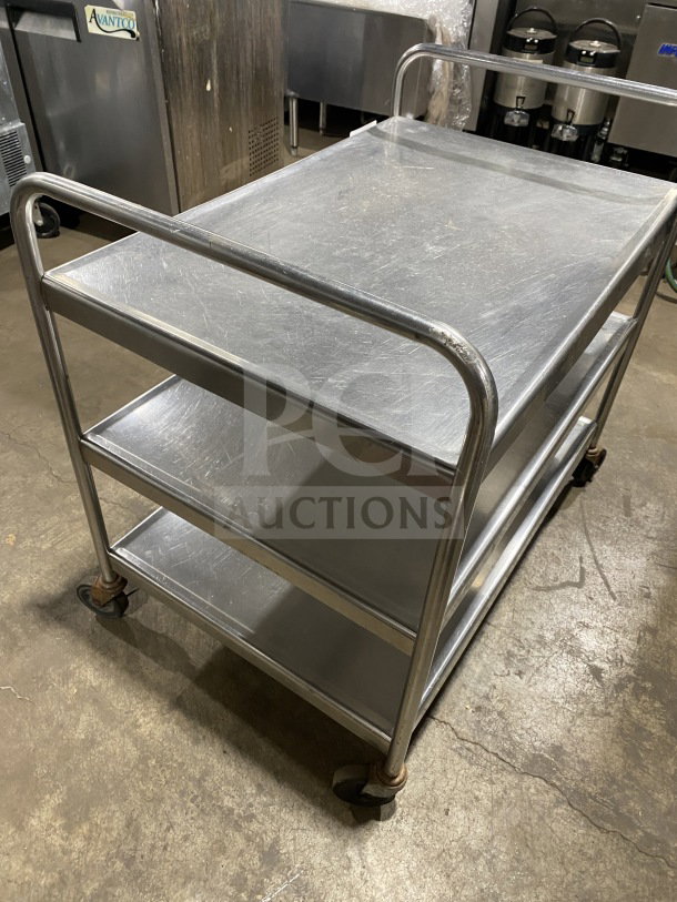 Commercial stainless steel utility trolley with 3 compartments on casters, fair condition, ideal for catering or storage use.