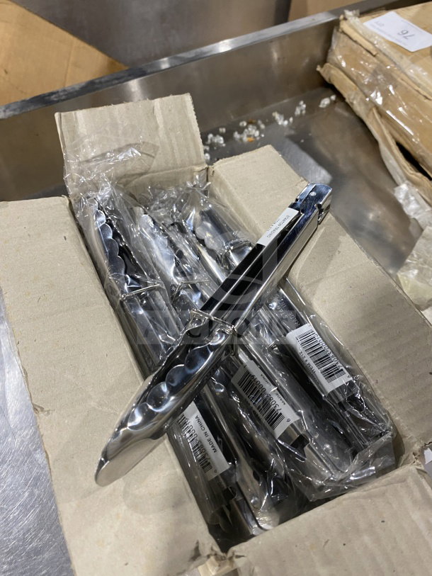 Stanton 9" stainless steel scalloped utility tongs, new condition, packaged in a cardboard box, factory labels visible.