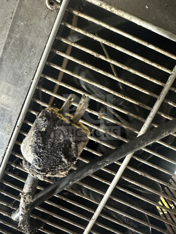 Dirty electrical plug on Beverage Air fridge model WTRCS60-1, showing wear. Grime buildup visible on grates.