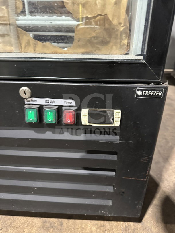 Commercial black gelato-style freezer, model SD240, with glass swing door, door heater, LED light, and control panel.