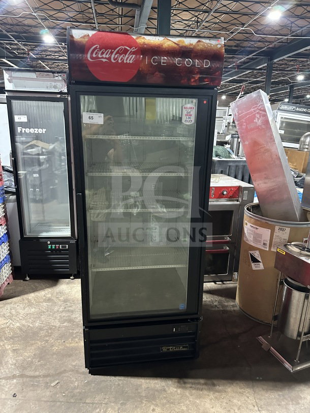 True GDM-26EM Coca-Cola black single glass-door refrigerated merchandiser, poly-coated wired rack, 115V, 1 Phase.