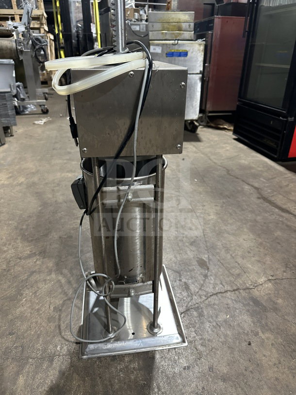 Commercial stainless steel electric sausage stuffer, countertop meat filling machine, working condition, with cables.