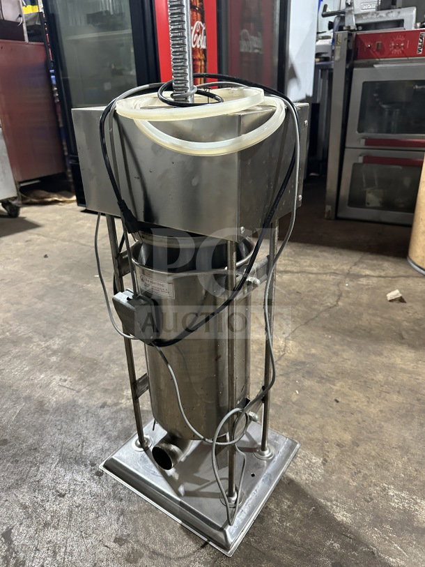 Commercial stainless steel electric sausage stuffer, countertop meat filling machine, working condition, visible cables.