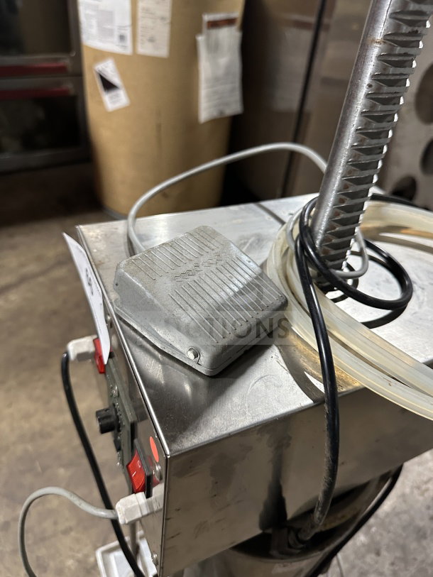 Commercial stainless steel electric sausage stuffer, countertop model, working condition, with control panel and wiring visible.