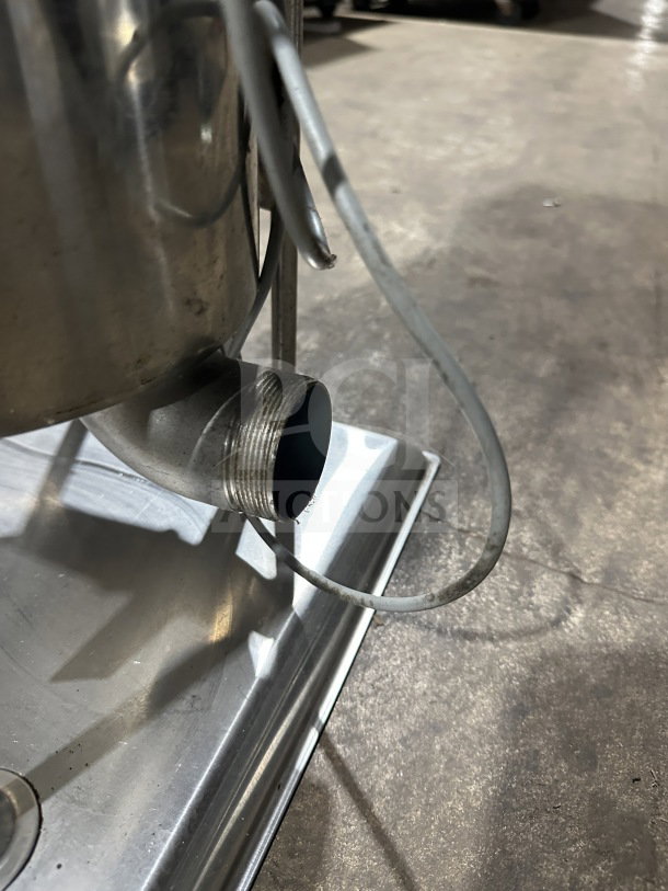 Commercial stainless steel electric sausage stuffer, shown with spout and cord. Used, but working when removed.