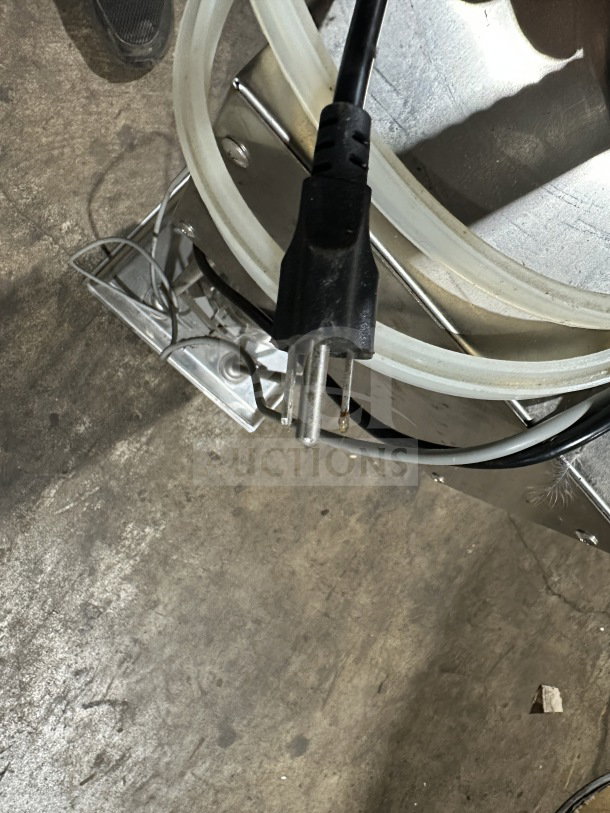 Commercial stainless steel electric sausage stuffer with power cord; used condition, countertop model.