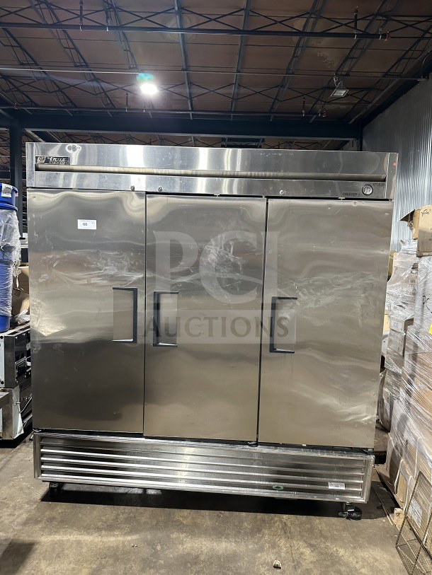 True T72-F commercial stainless steel 3-door reach-in freezer, with poly coated rack and casters, 115/208/230V.