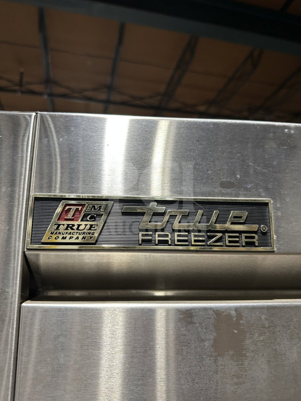 True T72-F commercial 3-door stainless steel freezer with poly-coated rack, on casters. Model label visible.