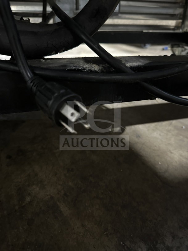 Power cord of True T72-F commercial 3-door stainless steel freezer on casters, showcasing its electrical plug.