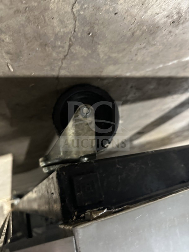 Close-up of a caster wheel on True T72-F stainless steel reach-in freezer, highlighting its mobility feature.