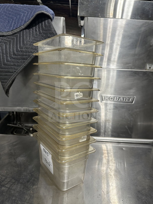 Stack of Cambro 631-1 translucent polypropylene food pans, full-size, 1/4x6", commercial use, visible wear and labels.