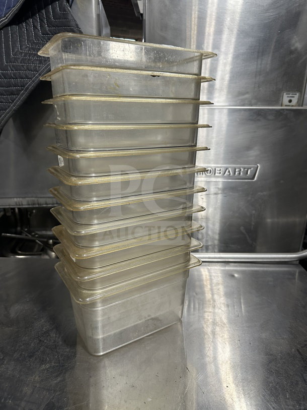 Stack of Cambro 631-1 translucent polypropylene food pans, full-size 1/4x6", used condition; essential for commercial kitchens.