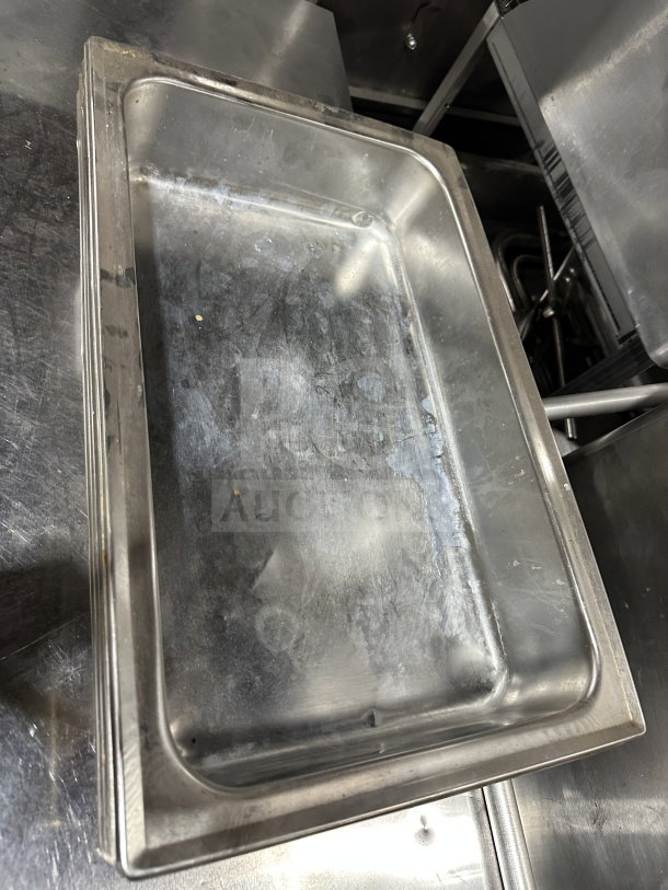 Commercial stainless steel steam table pan, used condition, rectangular shape. Ideal for food service applications.