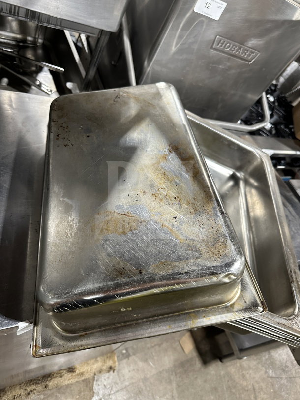 Commercial stainless steel steam table pan, used condition with visible wear; suitable for foodservice; stackable design.