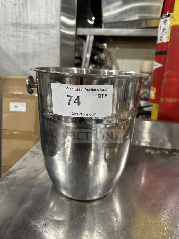 Stainless steel wine bucket/champagne chiller with handle. Features auction label "74." Used condition.