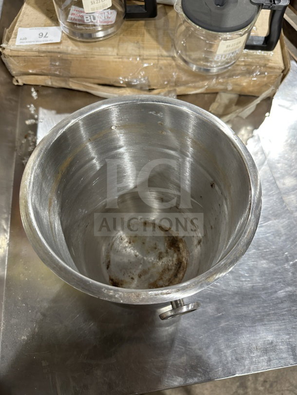 Commercial stainless steel wine bucket with handle, showing interior wear. Ideal for chilling wine or champagne.