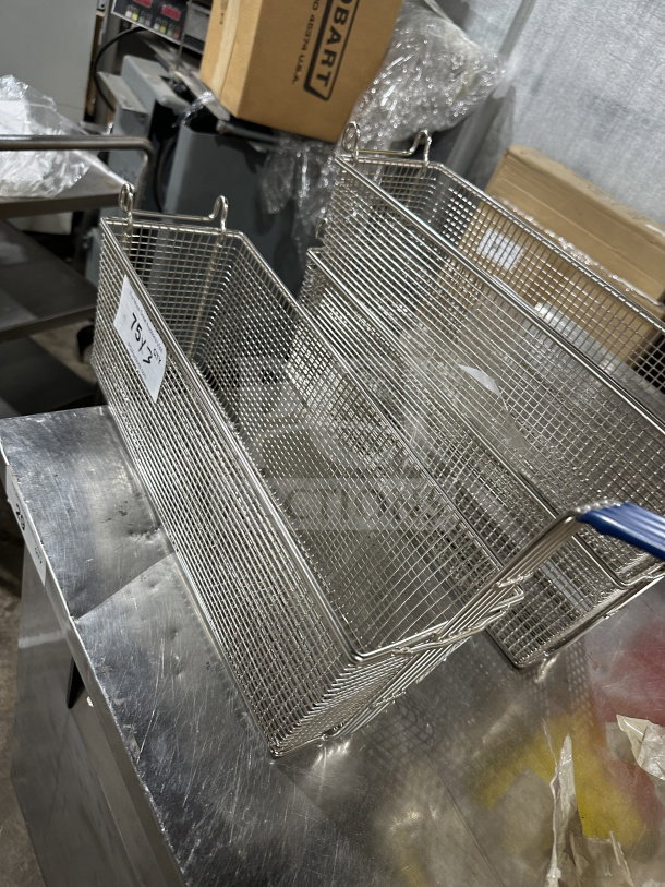 Commercial stainless steel deep fryer baskets with blue vinyl heat-resistant handles, like-new condition, perfect for kitchens.