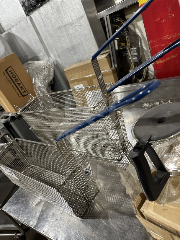 Commercial stainless steel deep fryer baskets with blue vinyl heat-resistant handles, excellent condition.