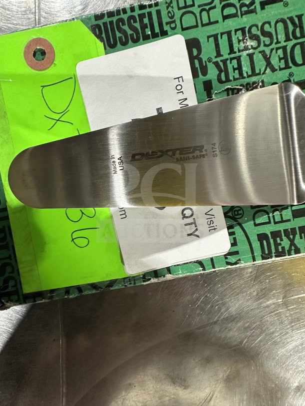 Brand new Dexter Russell S174 stainless steel offset spatula, with black grip handle. Marked "Made in USA" and "SAN-SAFE".