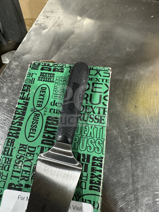 Brand new Dexter Russell S174 stainless steel offset spatula, black grip handle, original packaging, commercial-grade.