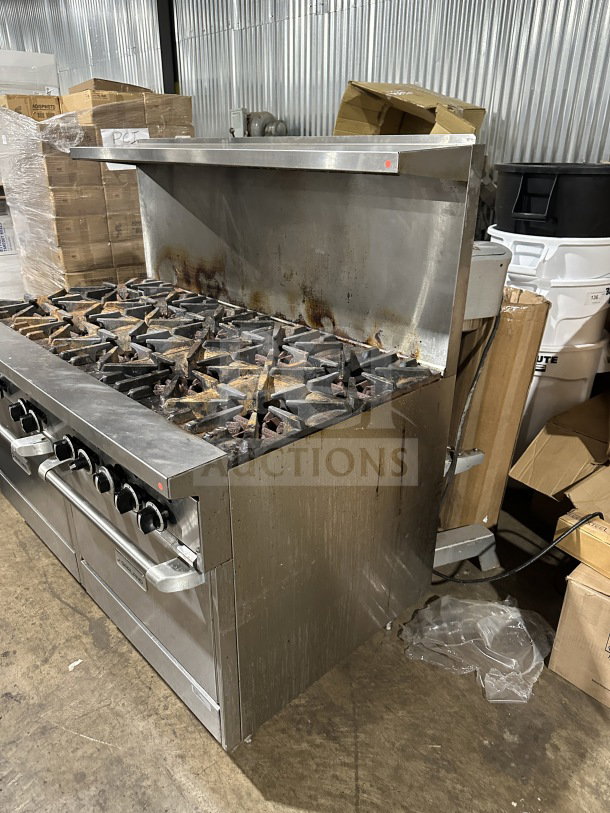 Garland stainless steel gas range, 10-burner, double oven combo with backsplash, wired oven rack, on legs. Used condition.