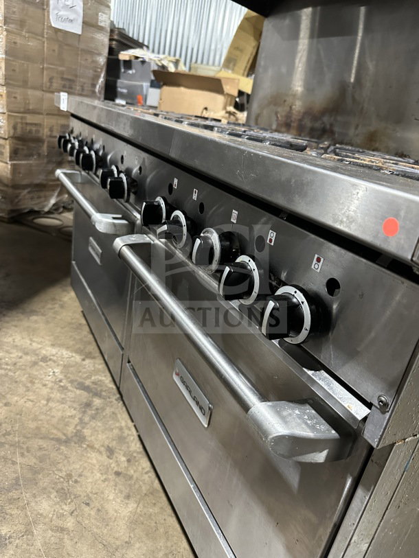 Garland stainless steel 10-burner range, double oven combo with backsplash, wired rack, on legs.