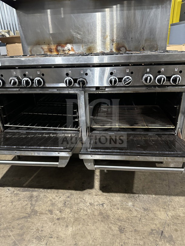 Garland commercial stainless steel 10-burner gas range with double oven, backsplash, wired oven rack, on legs, visible wear.