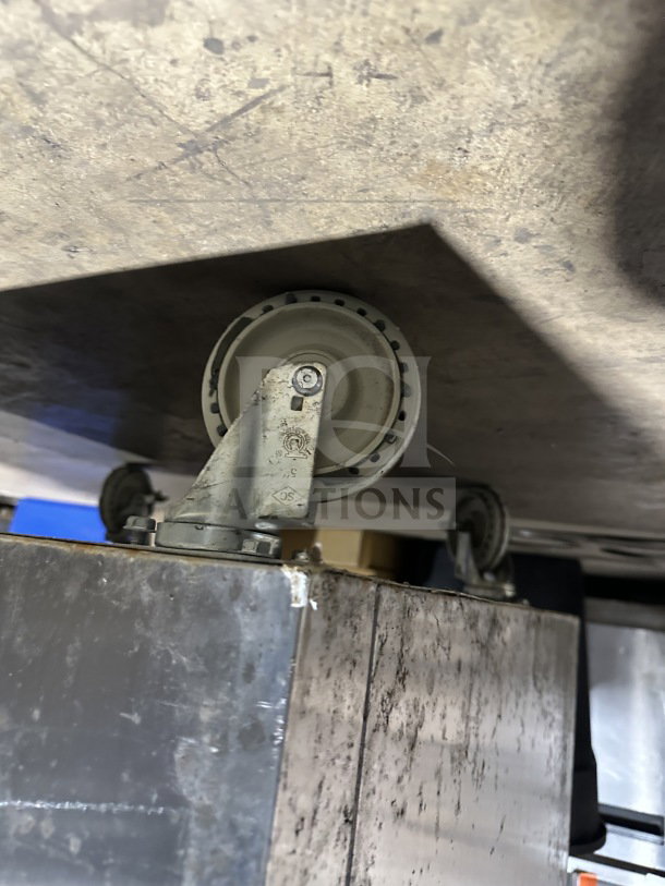 Delfield SSR1-SH13-21 commercial refrigerator caster. Stainless steel, shows wear. Model SSR1 SH 21. 115V, mobile on wheels.
