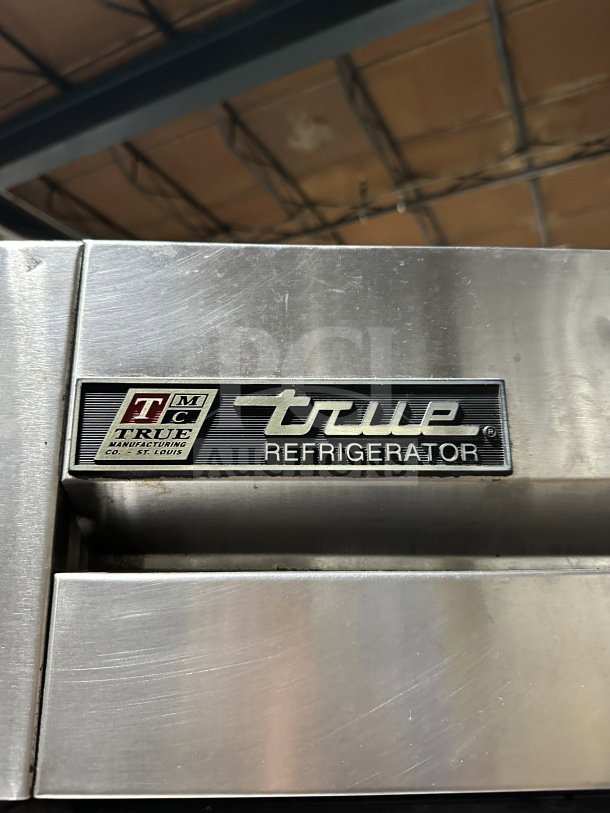 True T-49 stainless steel 2-door refrigerator, Energy Star, with poly-coated wired rack, on casters, model and logo visible.