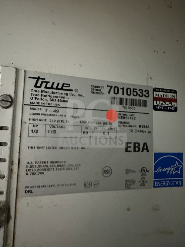 True T-49 commercial 2-door stainless steel refrigerator, Energy Star certified, poly-coated wire rack, casters, model label shown.