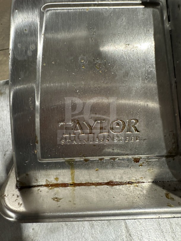 Taylor Commercial Stainless Steel 5 Lb. Food Portioning Scale; shows brand embossing; used condition with visible wear.