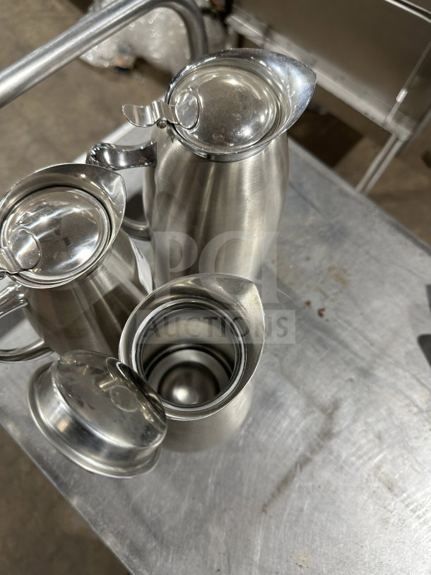 Bon Chef stainless steel vacuum-insulated beverage servers, excellent condition, hinged lids, sleek design, commercial-grade.