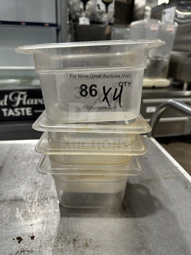 Stack of Plus commercial translucent polypropylene food pans, full-size. Auction label indicates 4 pans per bid.