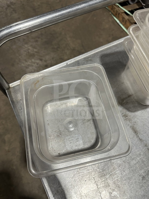 "Plus translucent polypropylene full-size food pan, commercial-grade, clear, gently used, on metal cart."