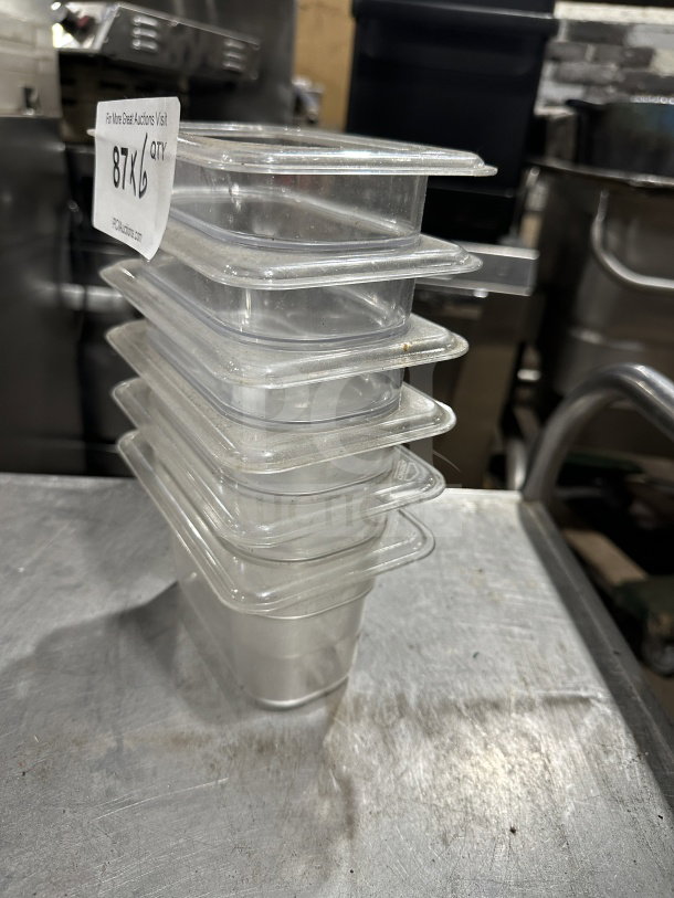 Vicor polycarbonate translucent full-size food pan stack, lightly used. Auction tag visible with lot number 87KL6.