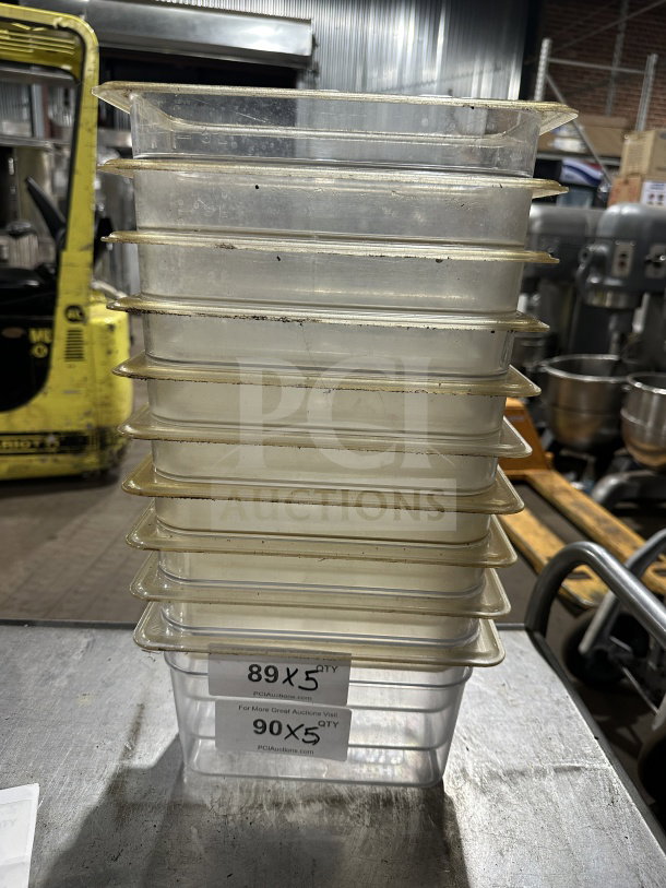 Cambro commercial polycarbonate translucent full-size food pans, stack of ten, used condition, auction lot labels visible.