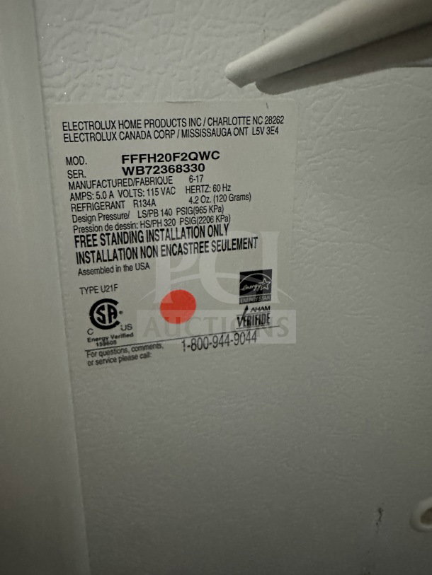 Frigidaire by Electrolux commercial freezer, model FFFH20F2QWC, white, Energy Star certified, SN WB72368330, 115V 1 phase. Tags show installation details and certification marks.