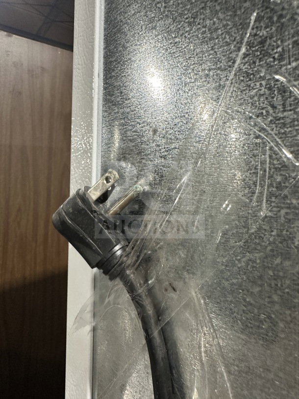 Frigidaire by Electrolux upright freezer plug detail, Model FFFH20F2QWC, showing electrical cord and textured surface.