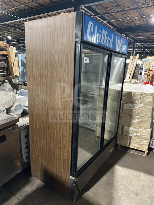 True GDM-49 commercial reach-in double glass door refrigerator with poly-coated wire rack, on casters, working condition.