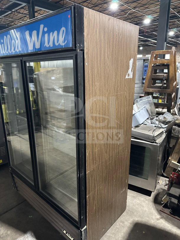 True Commercial GDM-49 refrigerator, double glass swing doors, poly coated racks, 115V, 1 Phase, on casters, working condition.