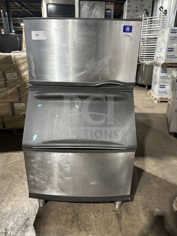 Manitowoc SY0304A stainless steel ice machine, air-cooled, electric-powered, on legs, visible labels and serial number, used condition.