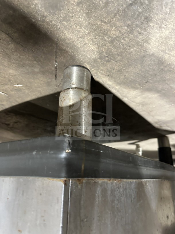 Manitowoc SY0304A ice machine leg, stainless steel finish, slight rust visible, sturdy construction.