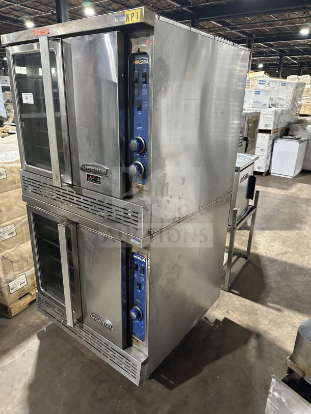 Imperial stainless steel gas double-stacked convection oven, commercial grade, with wired oven rack, on casters.