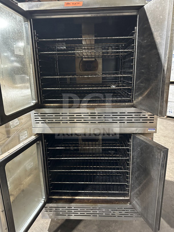 Imperial stainless steel double stacked gas convection oven with wired racks on casters. Good condition.