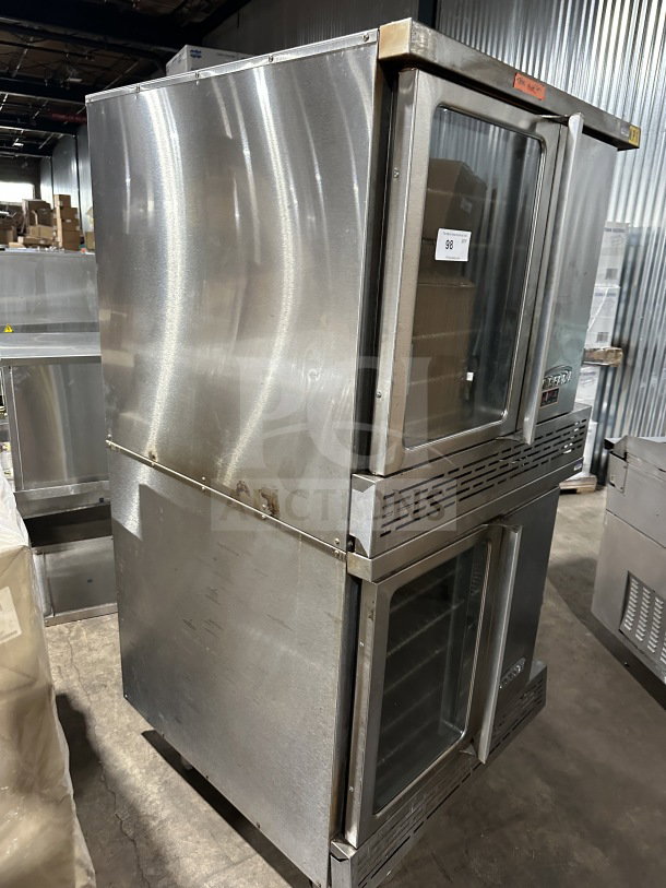 Imperial stainless steel double-stacked gas convection oven, on casters, with wired rack, shows some wear. Auction label reads "98."